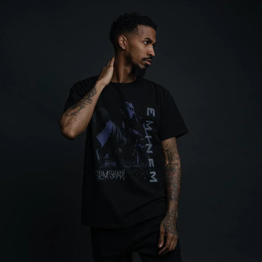 Male model showcasing the Throwback to '99 Eminem Vintage Style T-Shirt with a moonlit Eminem performance graphic and bold 'Slim Shady' text.