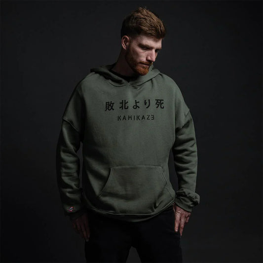 Eminem Kamikaze album-inspired official merchandise green hoodie front view on male model with Japanese characters and album title.