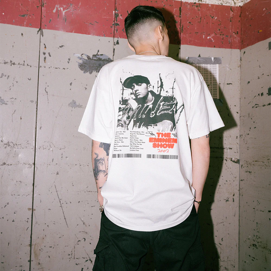 Model facing away, displaying the back of 'The Eminem Show T-Shirt' in white, featuring a large print with Eminem's portrait and album tracklist.