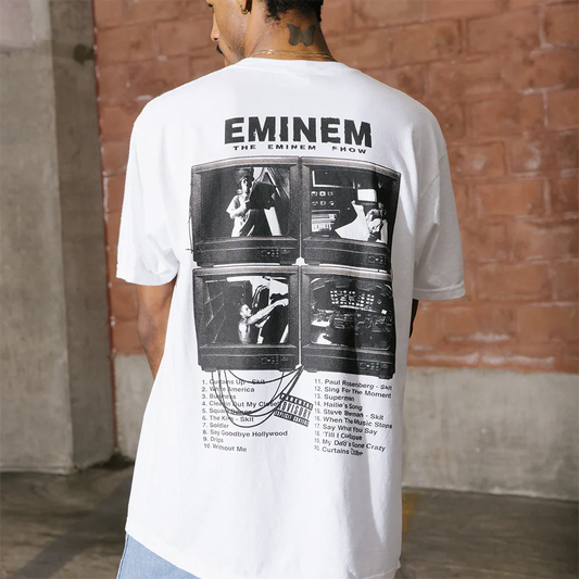Person sporting the Eminem Show 20th Anniversary Vintage TV T-Shirt, with a rear design featuring iconic images from the album tracks listed on an old-style television set.