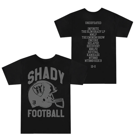 Two-sided view of the SHADY FOOTBALL T-shirt in black, with a prominent football helmet graphic on the front and a list of Eminem's albums symbolizing an undefeated streak on the back.