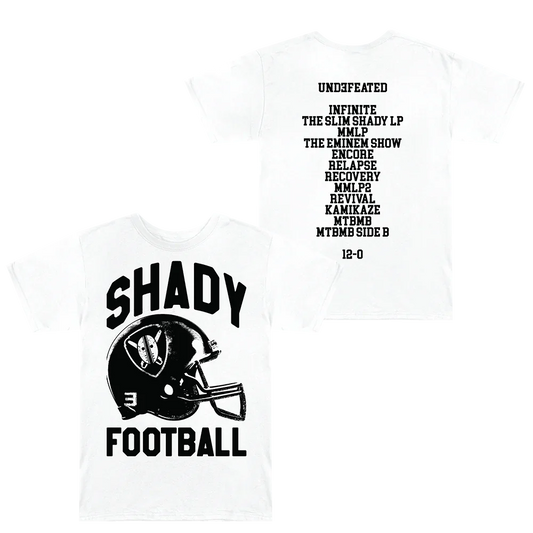 SHADY FOOTBALL T-shirt in white displayed with front featuring a bold 'SHADY FOOTBALL' helmet graphic and back listing Eminem's undefeated album history.