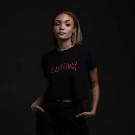 Confident model in a black Slim Shady Signature Cropped T-Shirt featuring the iconic Slim Shady script in bold red.