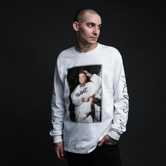 Male model posing in a white long sleeve 'I'm Shady' shirt with a vintage 1999 Eminem photo print and signature text down the sleeves.